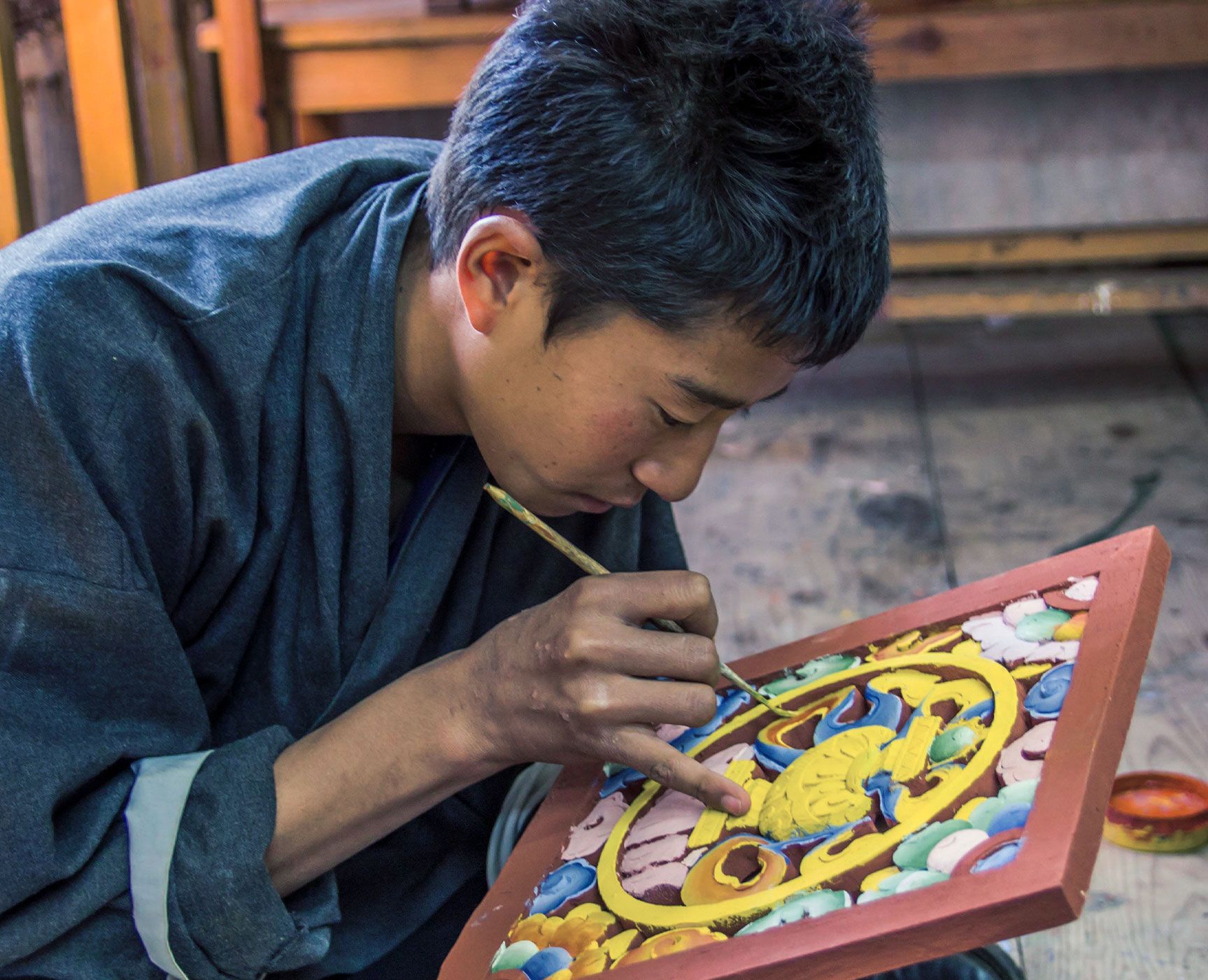The Dariu Foundation - Bhutan - Man painting Mandala
